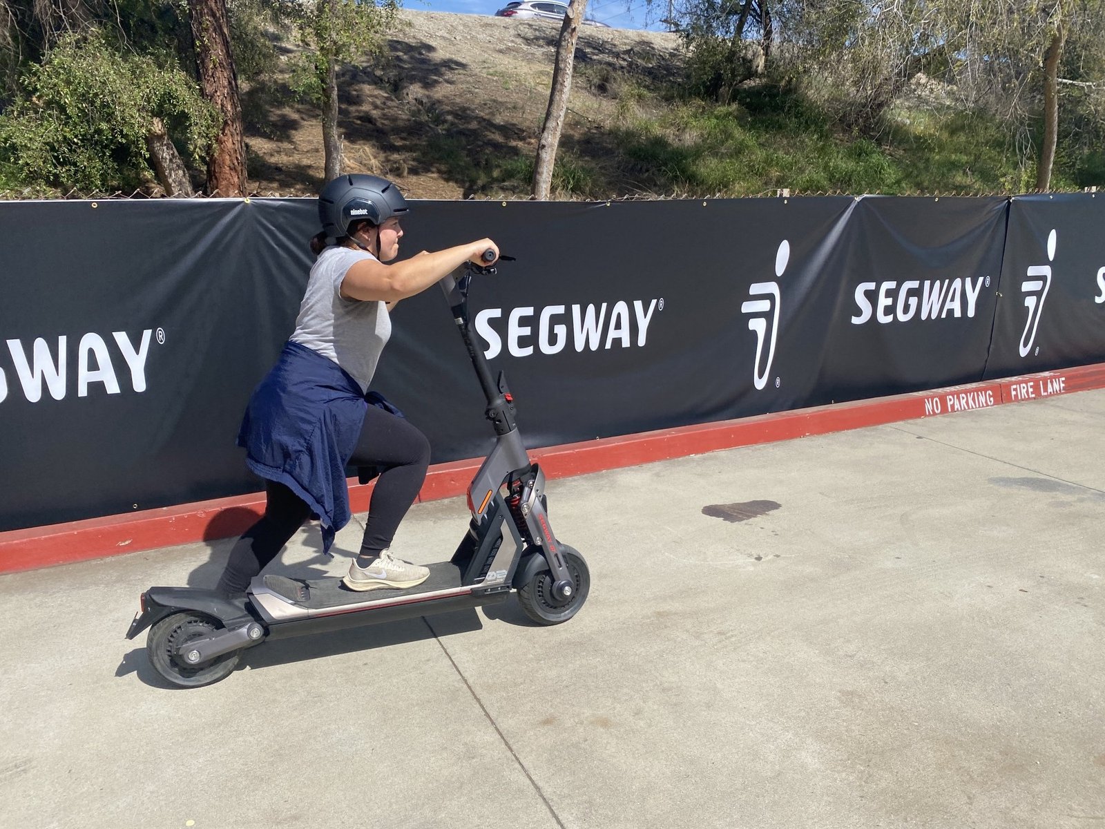 Mashable reporter kicking off on a Segway e-scooter.