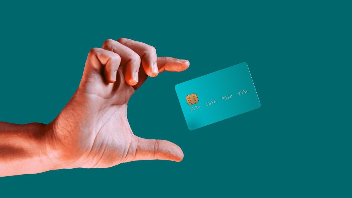 Hand reaches for credit card