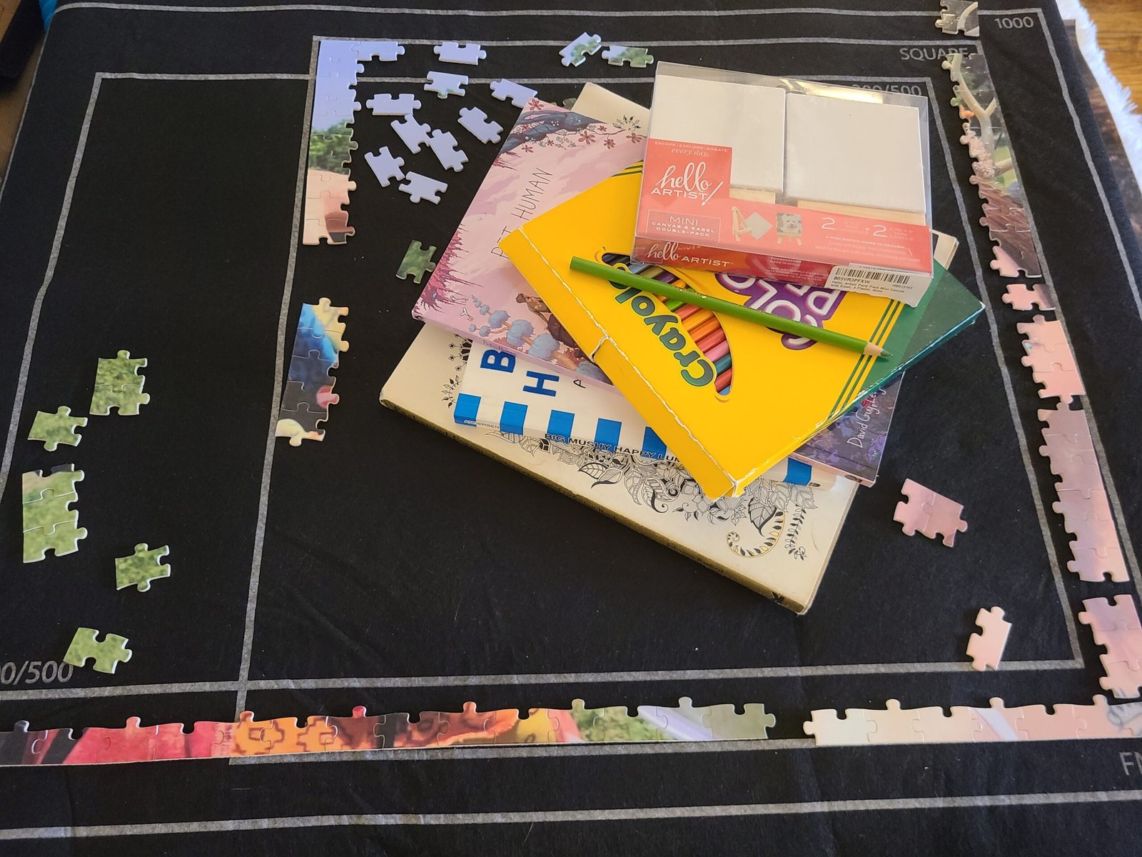 A table with a puzzle and arts and crafts supplies