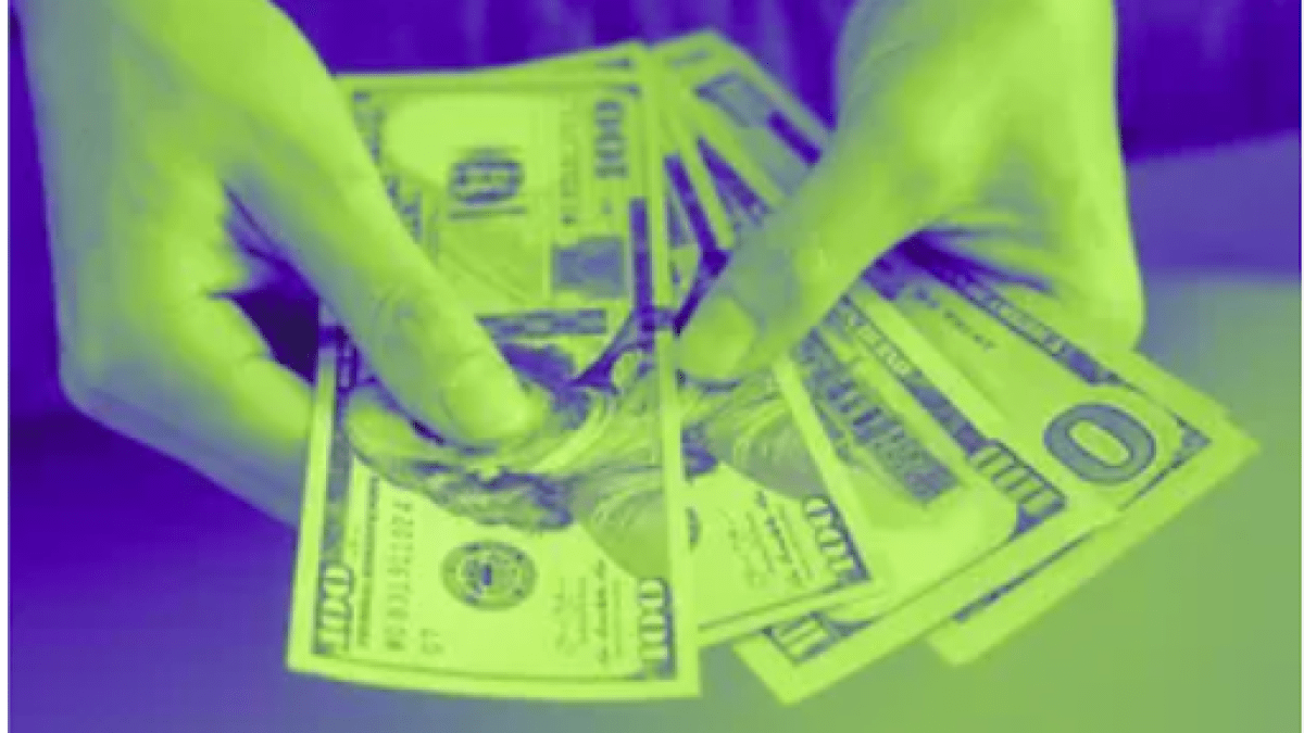 Hand with hundred dollar bills