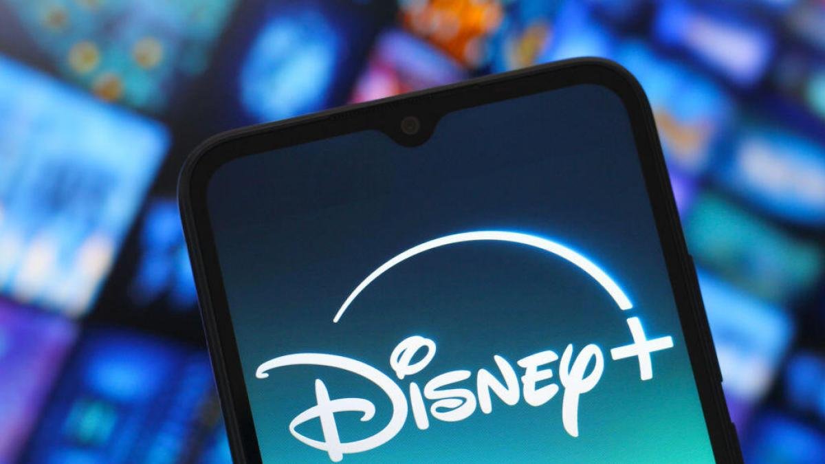 Disney Plus logo on a smartphone on blue background