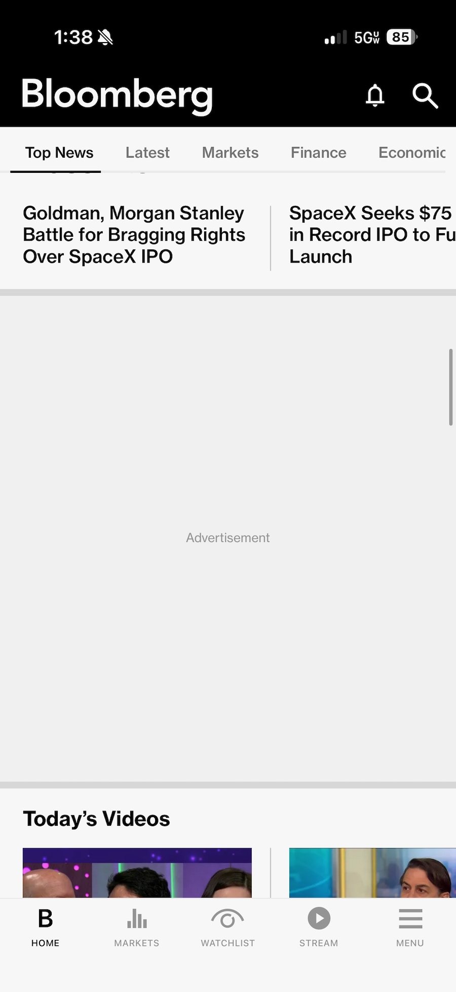 a screenshot of the Bloomberg iOS app with ads blocked and just showing a grey rectangle with the word "Advertisement."