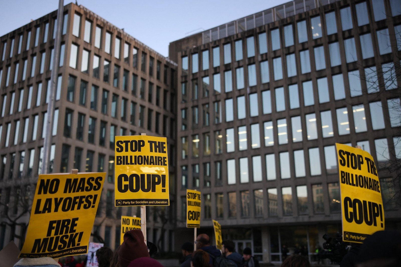 Demonstrators gather outside of the Office of Personnel Management in Washington, D.C. on February 7, 2025 to protest federal layoffs and demand the termination of Elon Musk from the Department of Government Efficiency (DOGE). (Photo by Bryan Dozier / Middle East Images / Middle East Images via AFP)