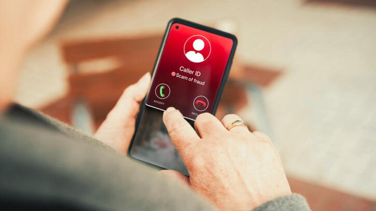 woman holding phone with incoming spam call