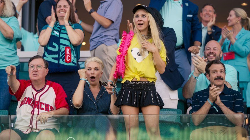 The cast of Ted Lasso season 4 applauding from the stands.
